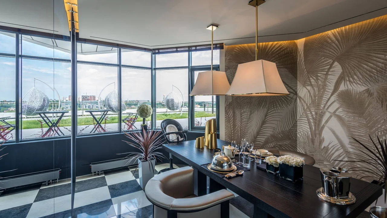 Elegant office space with modern design, featuring luxurious furniture and a scenic glass wall view.