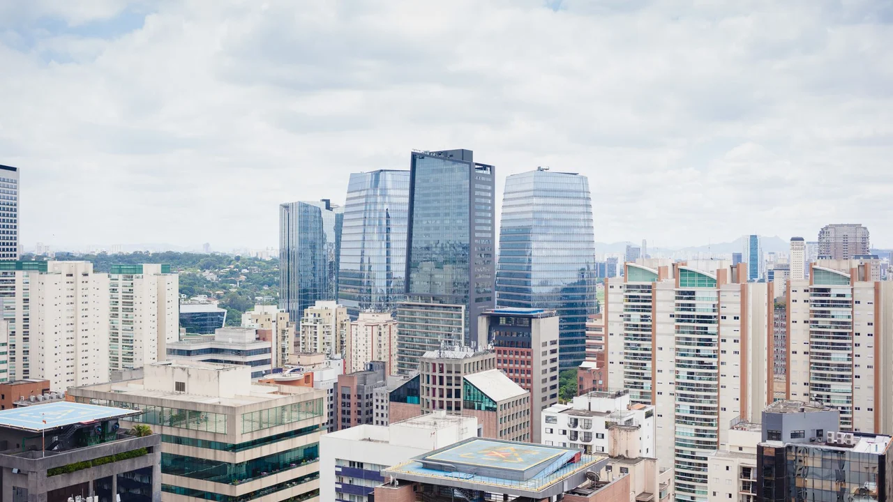 Aerial view of Sao Paulo showcasing modern architecture and skyline under a cloudy sky.