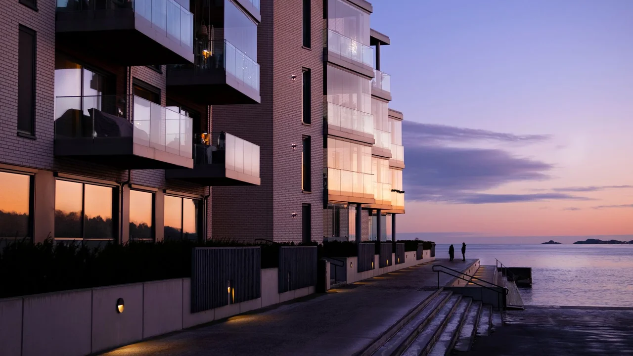 Contemporary apartment building overlooking the seacoast at sunset, capturing a serene evening ambiance.