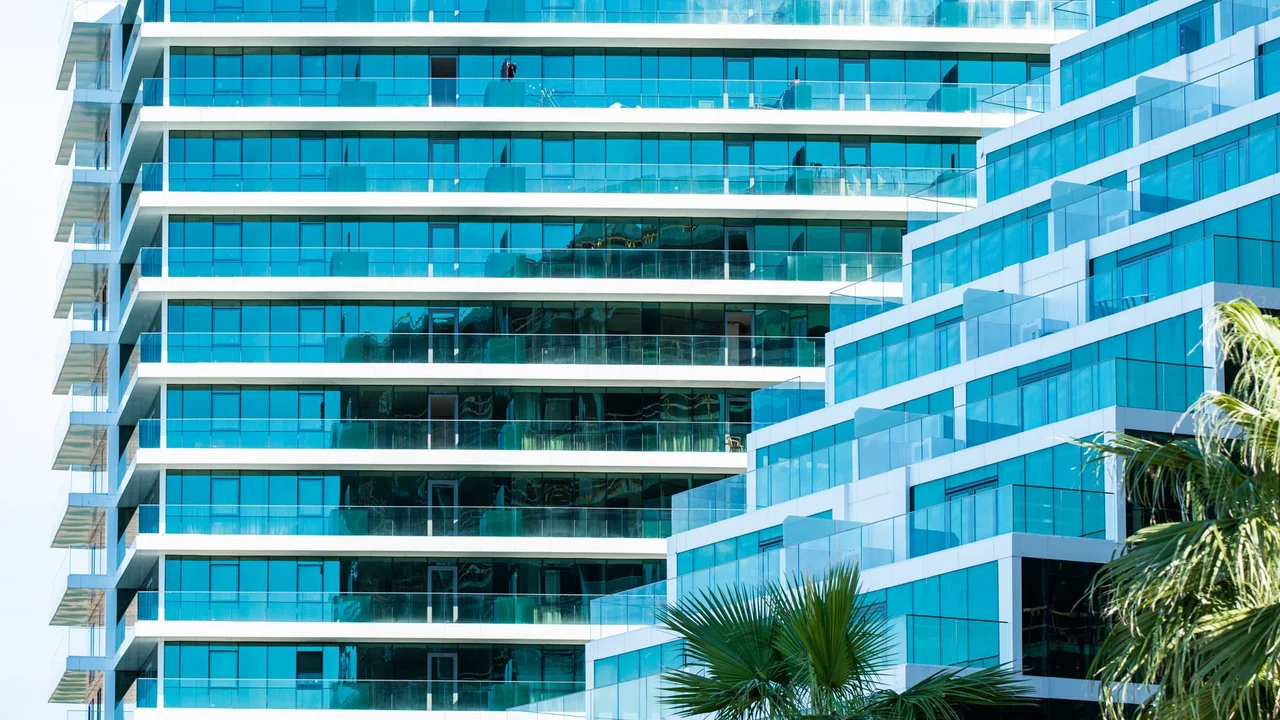 A contemporary glass building facade showcasing modern architecture and reflections.