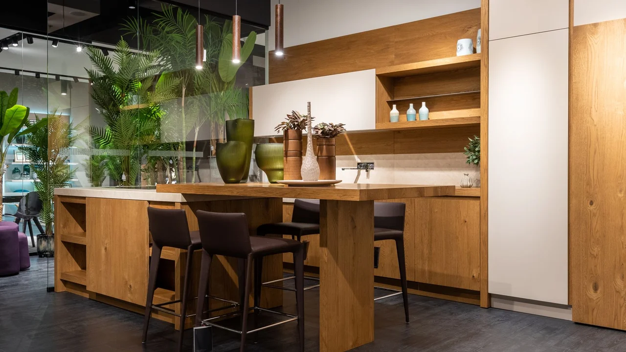 Modern fancy kitchen interior design with trendy furniture and decorative glass wall and vases