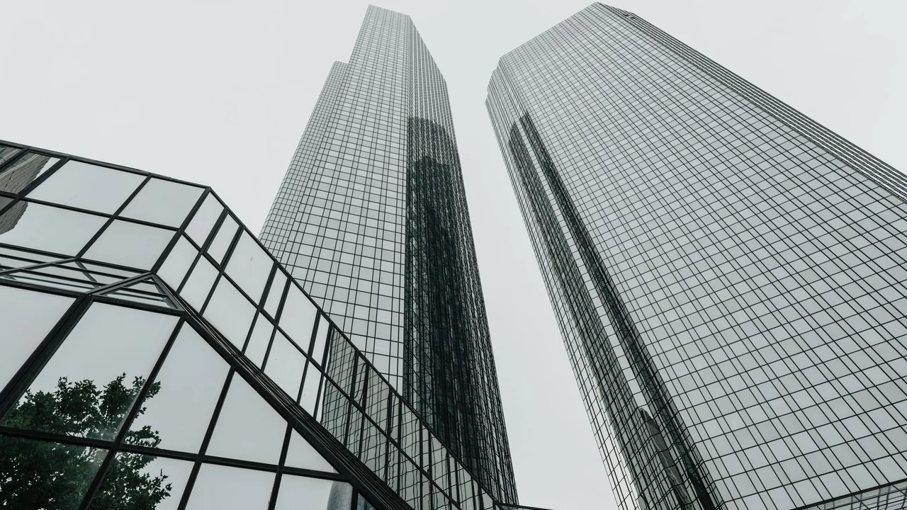 A contemporary glass building facade showcasing modern architecture and reflections.